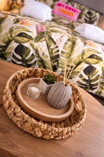 a wooden tray with a mortar and pestle on a table at Grass Roots Retreat in Llanstadwell