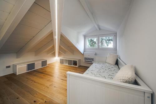 an attic room with a bed and a window at Attico Mansardato con terrazzo privato in Monza