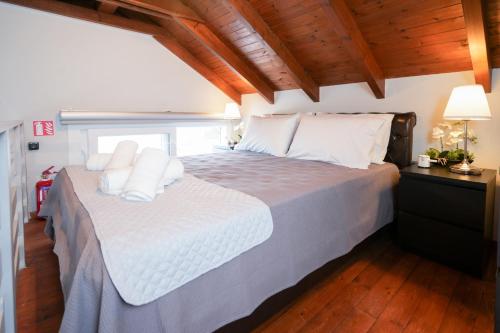 a bedroom with a large bed with white pillows at Aegean Balcony Apartment in Nea Peramos