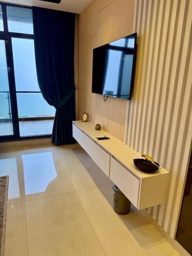a room with a white desk with a tv on the wall at Premium Murree Apartment With Stunning Views in Murree