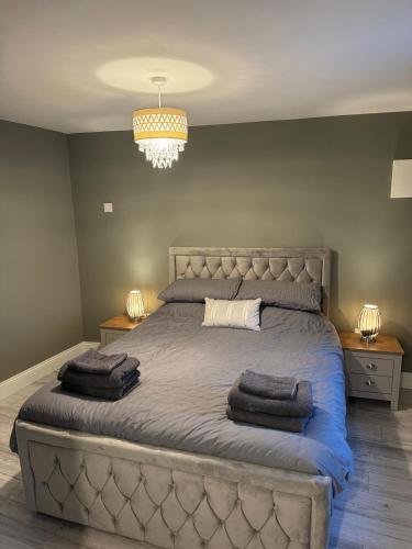 a bedroom with a large bed with two towels on it at Shrule Cosy Nest in Shruthair