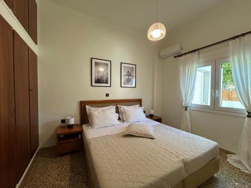 a bedroom with a bed and a window at MG elounda apt in Elounda
