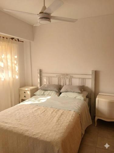 a bedroom with a bed and a ceiling fan at Studio Roca in Rosario