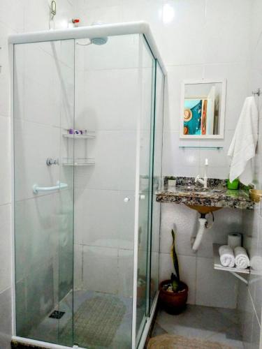 a shower with a glass door in a bathroom at Rancho Magic in Cabo Frio