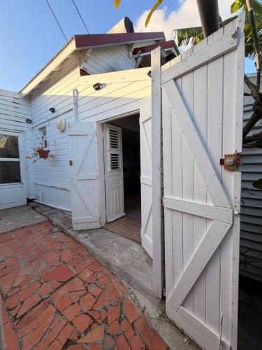 an entrance to a garage with an open door at Villa Lumineuse in Le Lamentin