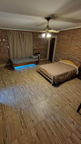 an empty room with two beds and a ceiling at margarita in Sauce Viejo