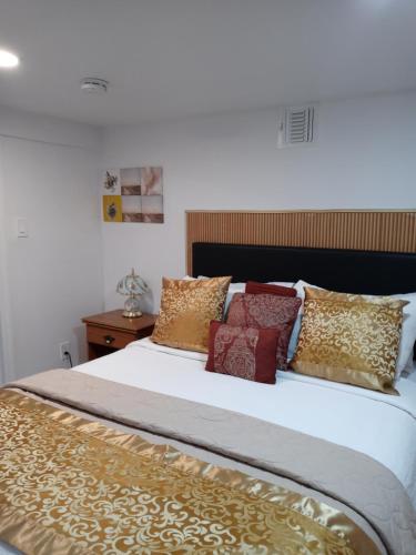 a bedroom with a large bed with pillows on it at "Cozy Basement Retreat Just 40 Minutes to NYC!" in Irvington