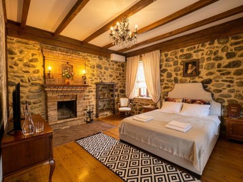 a bedroom with a bed and a fireplace at Villa Khodasheni in Kʼvemo Khodasheni