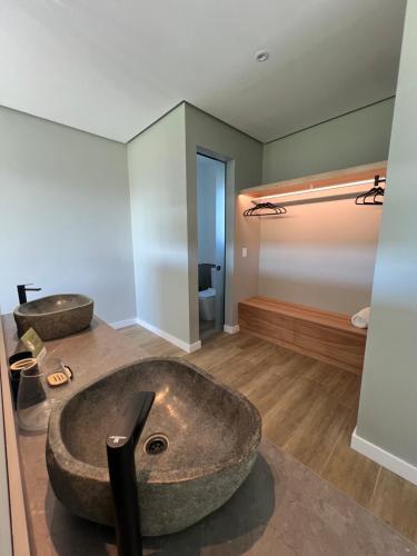 a bathroom with two sinks in a room at Buenos Vientos Casa de Campo in Maldonado