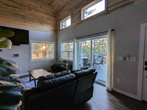 a living room with a couch and a table at Pinetop Getaway w Sunset Deck & Fire Pit Table in Pinetop-Lakeside
