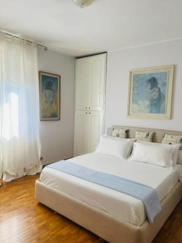a large white bed in a room with a window at Villa Francesca BeB in Grumello del Monte
