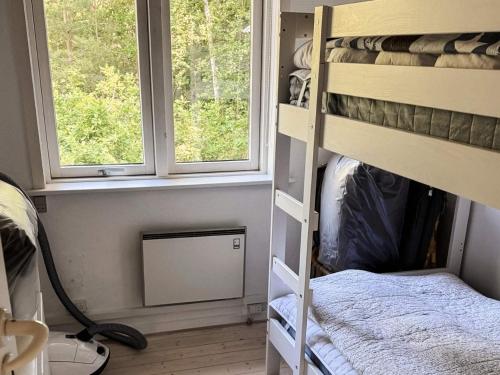 a room with two bunk beds and two windows at 4 person holiday home in Læsø-By Traum in Læsø