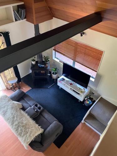 an overhead view of a living room with a couch and a television at Fernside Tranquil Retreat in Pauanui