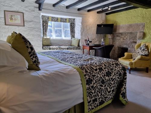 a bedroom with a large bed in a room at The Oxenham Arms Hotel Devon in South Zeal