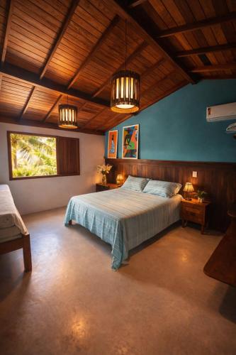 a bedroom with a large bed in a room at Varanda do Mar Caraíva Oceanfront in Porto Seguro