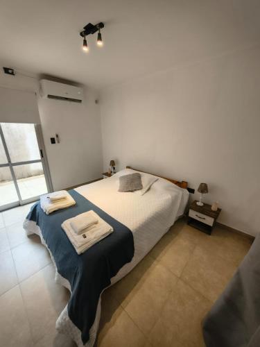 a bedroom with a bed with two towels on it at Aloha 2 in Chacabuco