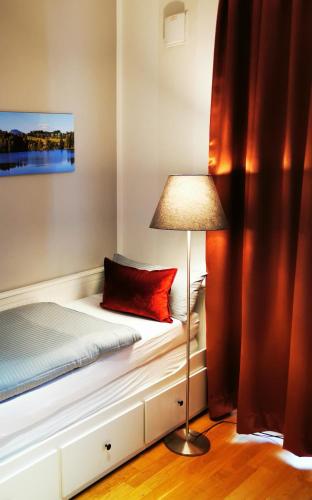 a small bedroom with a bed with a lamp at Top-Apartment a.d. Messe in Munich