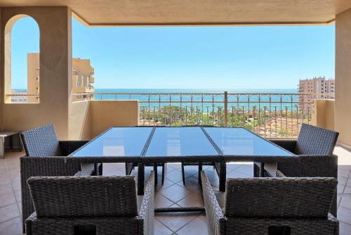 a table and chairs on a balcony with a view at Bella Sirena Resort Stellar View C601 in Puerto Peñasco