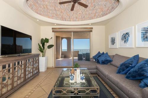 a living room with a couch and a tv at Bella Sirena Resort Stellar View C601 in Puerto Peñasco