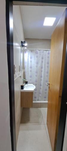 a bathroom with a sink and a shower curtain at Apartment for 2 people - Jorge One in Adrogue