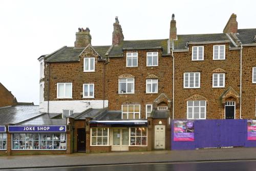 a large brick building on the side of a street at Hunstanton Holidays Flat 3 with seaview in Hunstanton