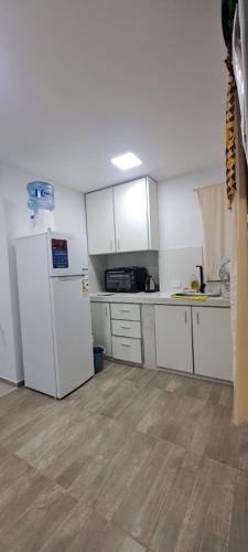 a kitchen with white cabinets and a refrigerator at Apartament for 2 people - Jorge Two in Adrogue