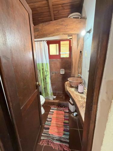 a small bathroom with a sink and a toilet at Mar y Sal in Punta Del Diablo