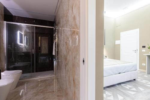 a bathroom with a shower and a toilet and a sink at Maison 900 in Tivoli