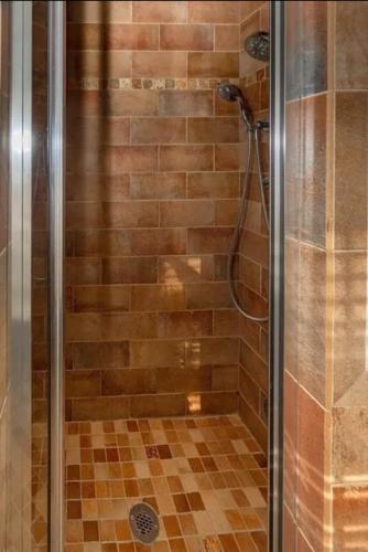 a shower with a glass door in a bathroom at GorgeousWestwood in Westwood