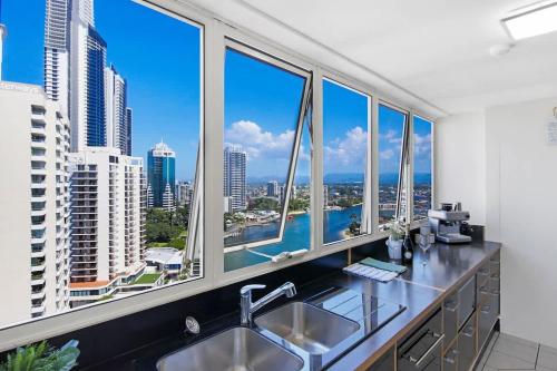 a kitchen with a large window with a view of the city at Salt & Sky Arcade - Sleeps 12 in Gold Coast