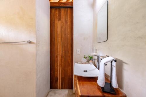 a bathroom with a sink and a mirror at Luxury Jungle Suite with Private Jacuzzi & Cenote Pool View in Chemuyil