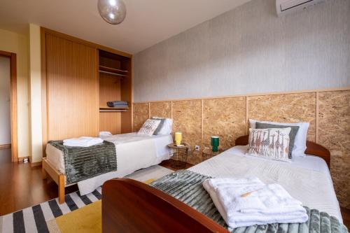 a hotel room with two beds in a room at A casa da Girafa in Ponta Delgada
