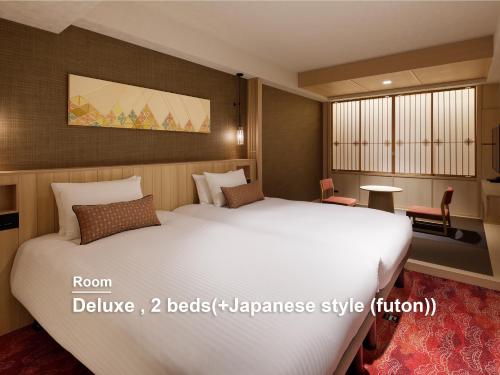 a bedroom with a large white bed in a room at Mitsui Garden Hotel Kyoto Shinmachi Bettei in Kyoto