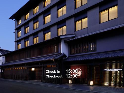 a black building with a sign in front of it at Mitsui Garden Hotel Kyoto Shinmachi Bettei in Kyoto