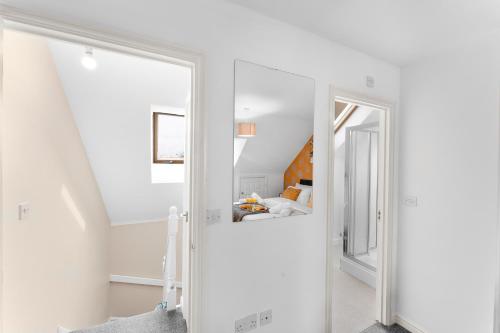 a white room with a door leading to a bedroom at 3-Bedrm, Parking, Soccer Table, Sleeps 7 in Cannock