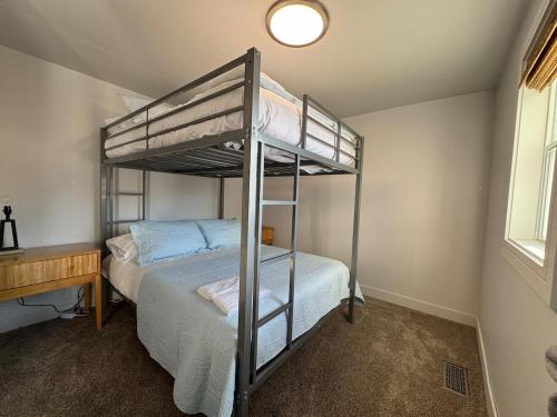 a bedroom with two bunk beds and a desk at Cozy cabin by the lake in Spring Lake