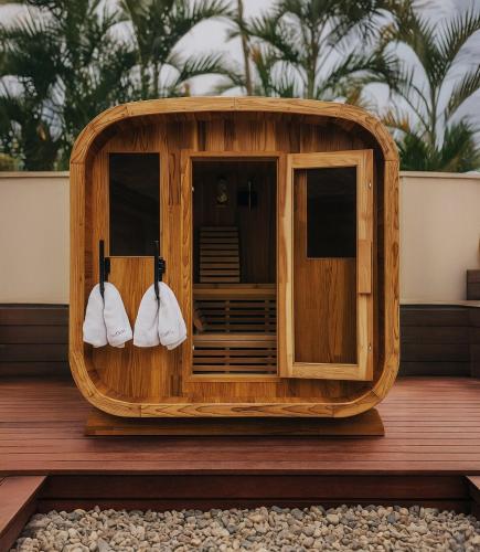 a wooden sauna with three white shoes in it at Emmaus Hill in Blue Haven
