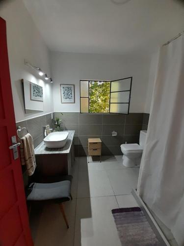 a bathroom with a sink and a toilet at La Chaira in Santa Ana