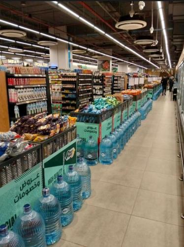 a store aisle filled with lots of bottles of water at Porto El Sokhna in Ain Sokhna