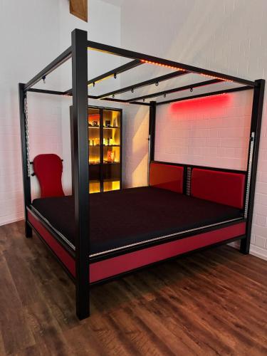 a black bunk bed in a room at Red Silence I Design Suite im Koblenz in Bendorf