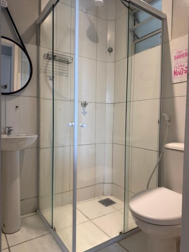 a shower in a bathroom with a toilet and a sink at Encanto Parangaba in Fortaleza