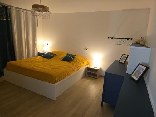a bedroom with a bed with yellow sheets and two night stands at Premium Villa, Maison du Manguier in Les Anses-dʼArlets
