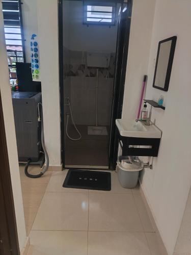 a bathroom with a shower and a sink at D'sawah Guest House in Kota Bharu