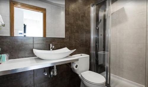 a bathroom with a sink and a toilet and a shower at Hotel Itxas Gain Getaria in Getaria