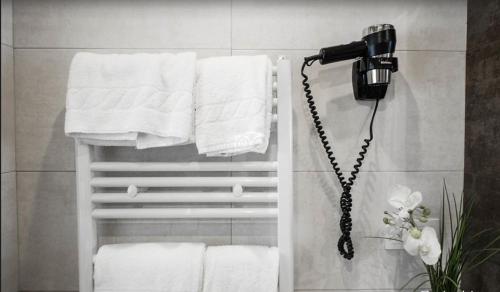a blow dryer in a bathroom with towels at Hotel Itxas Gain Getaria in Getaria
