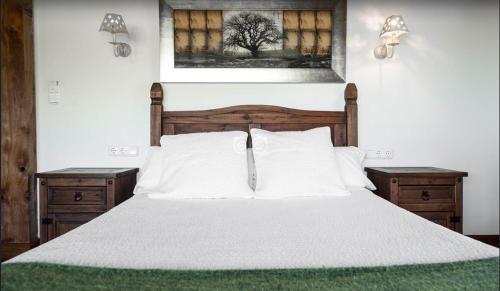 a bed with white sheets and pillows in a bedroom at Hotel Itxas Gain Getaria in Getaria