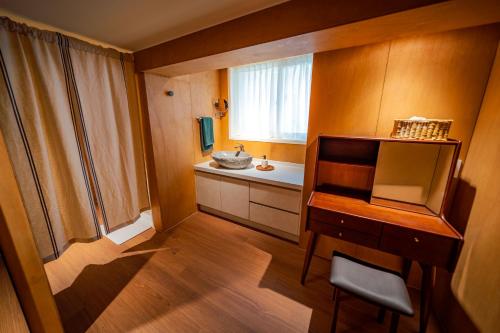 a small bathroom with a sink and a desk at On Stay - Hotel Quality Stay in Seoul