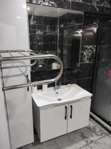 a bathroom with a white sink and a mirror at Hostel in Yakuplu