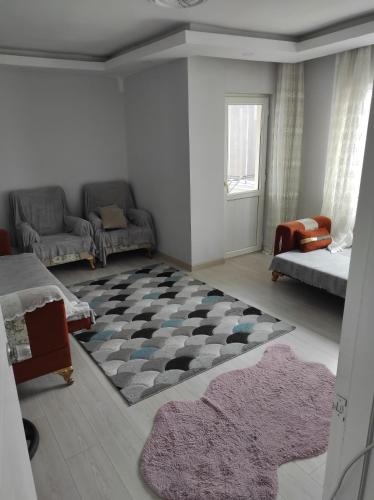 a living room with a couch and a rug at Hostel in Yakuplu