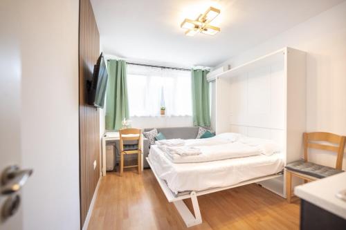 a hotel room with a bed and a desk and a bedroom at Boho Spa Apartments with Sauna in Sofia
